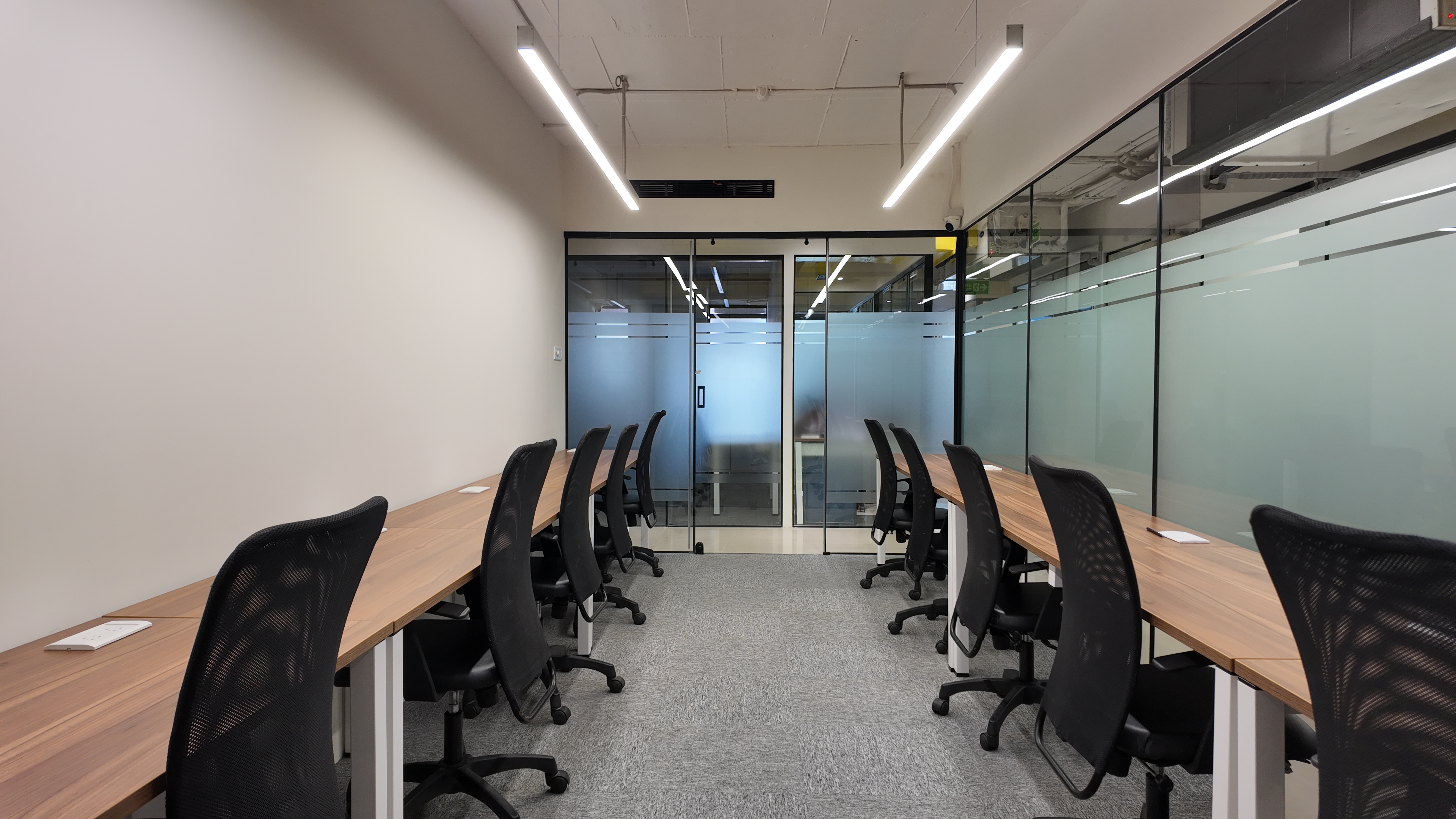 Organized fixed desks for work at Community Coworks